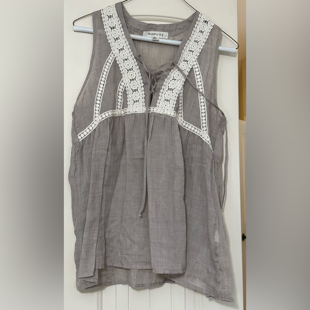 Small tank. Super light weight and really cute tucked into shorts!
